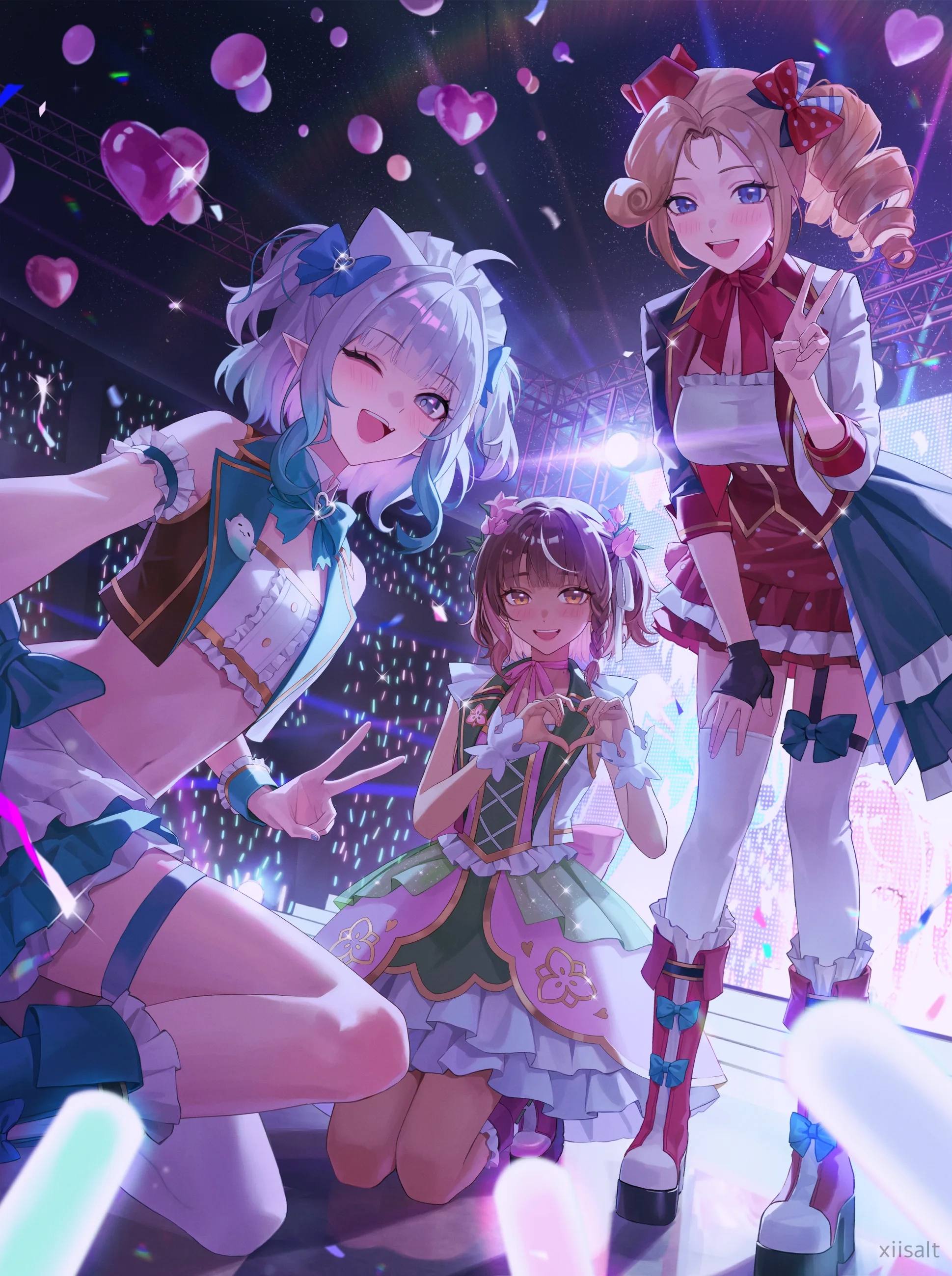 Four performers posing under violet stage lights